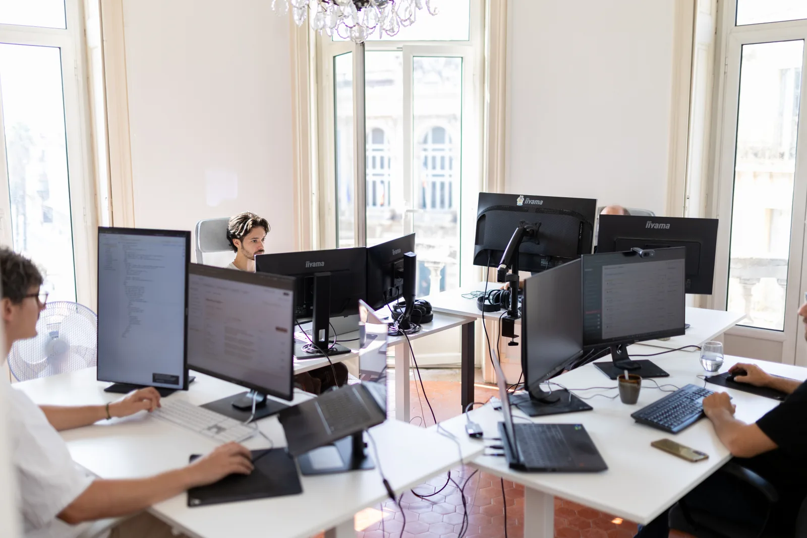 The Arkyan team working at their desks in the bright Montpellier office
